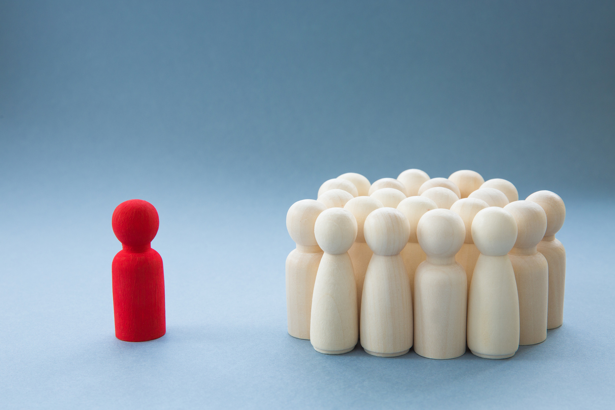 A Manager or Leader addressing a group of people or being isolated because of diversity leading in strange times